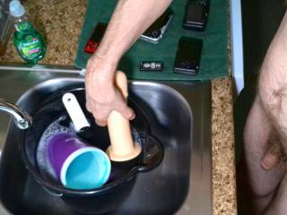 I dick scene as I stand near my kitchen sink as I invert my toy, before I place it into the pail for soaking/washing in December of 2023. Vlog camera was used.
