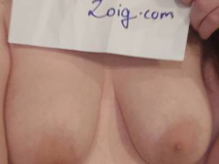 A photo of me holding a sign and showing my tits for verification purposes.