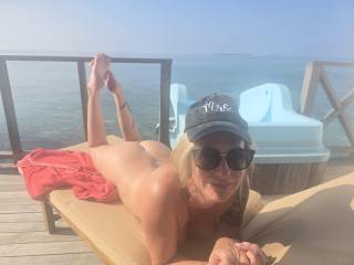 Just tanning her ass and flashing the seaplanes in the Maldives