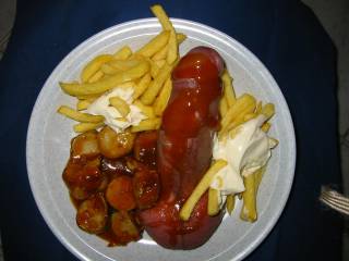 German speciality, called "Pommes mit Cyrrywurst"