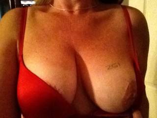 Your not fooling me cutie ;) we know you tagged it to show it off. BTW you look simply delicious in Red, this bra especially looks made for you. Now that we caught you "Red" handed being a naughty tease, go ahead and let your inner Slut-MILF out to play ;). Pull that other lovely breast out for display, wrap one arm under them as you tease around your panties with your other hand giving us sensory overload =) Please? ;).