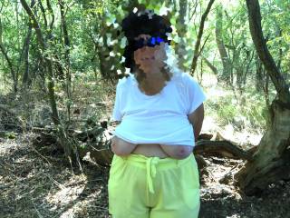 A lady wearing sunglasses is tied to the tree behind her. Only loosely, as later he wants her to get on her knees ...