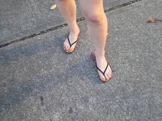 Full view of those orange sexy long toes and nice legs in black flip flops