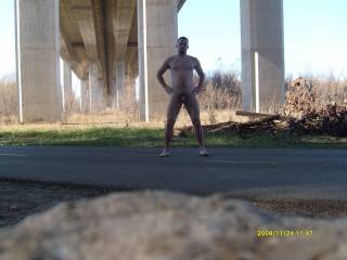 Nude under a highway overpass.