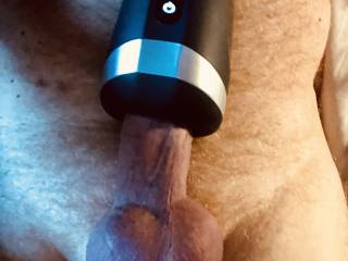 Massaging my penis with a heated vibrator.